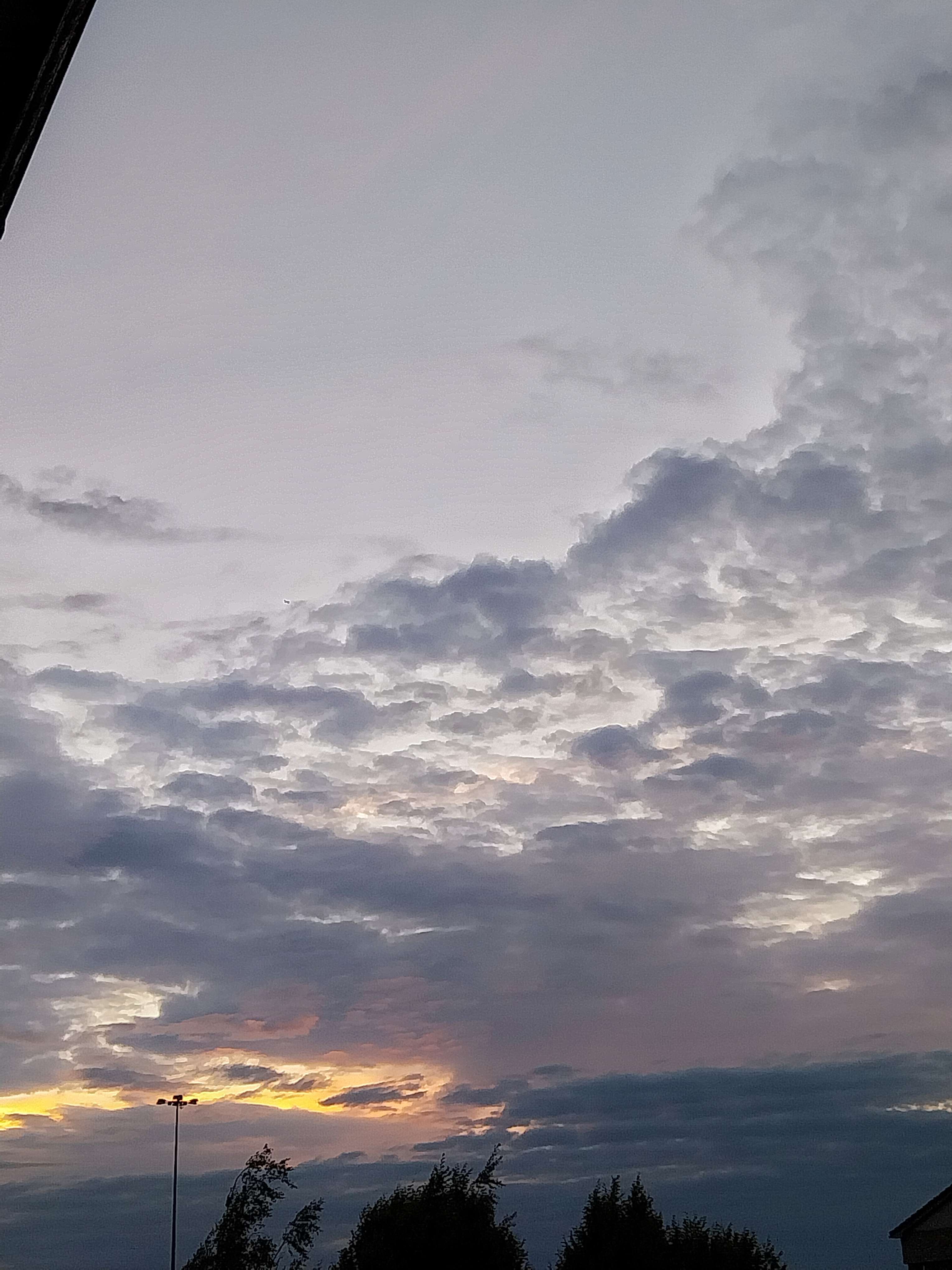 A cloudy sky of a sunset with a painted look.